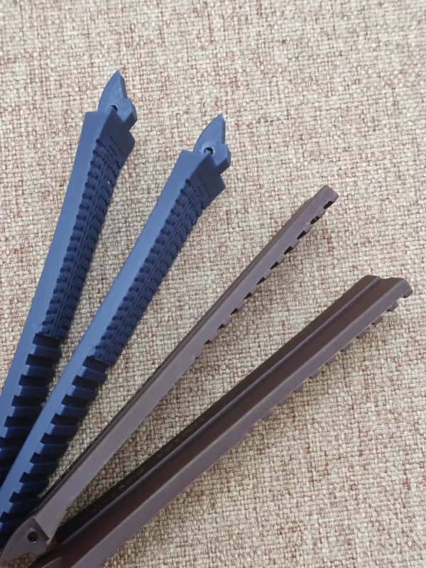 Four rubber straps for Porsche Design P6360 in blue and brown, laid out on a beige fabric surface.