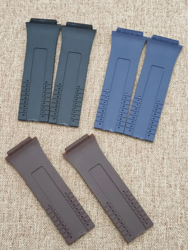 Six rubber straps for Porsche Design P6780 in black, blue and brown, with adjustment holes.