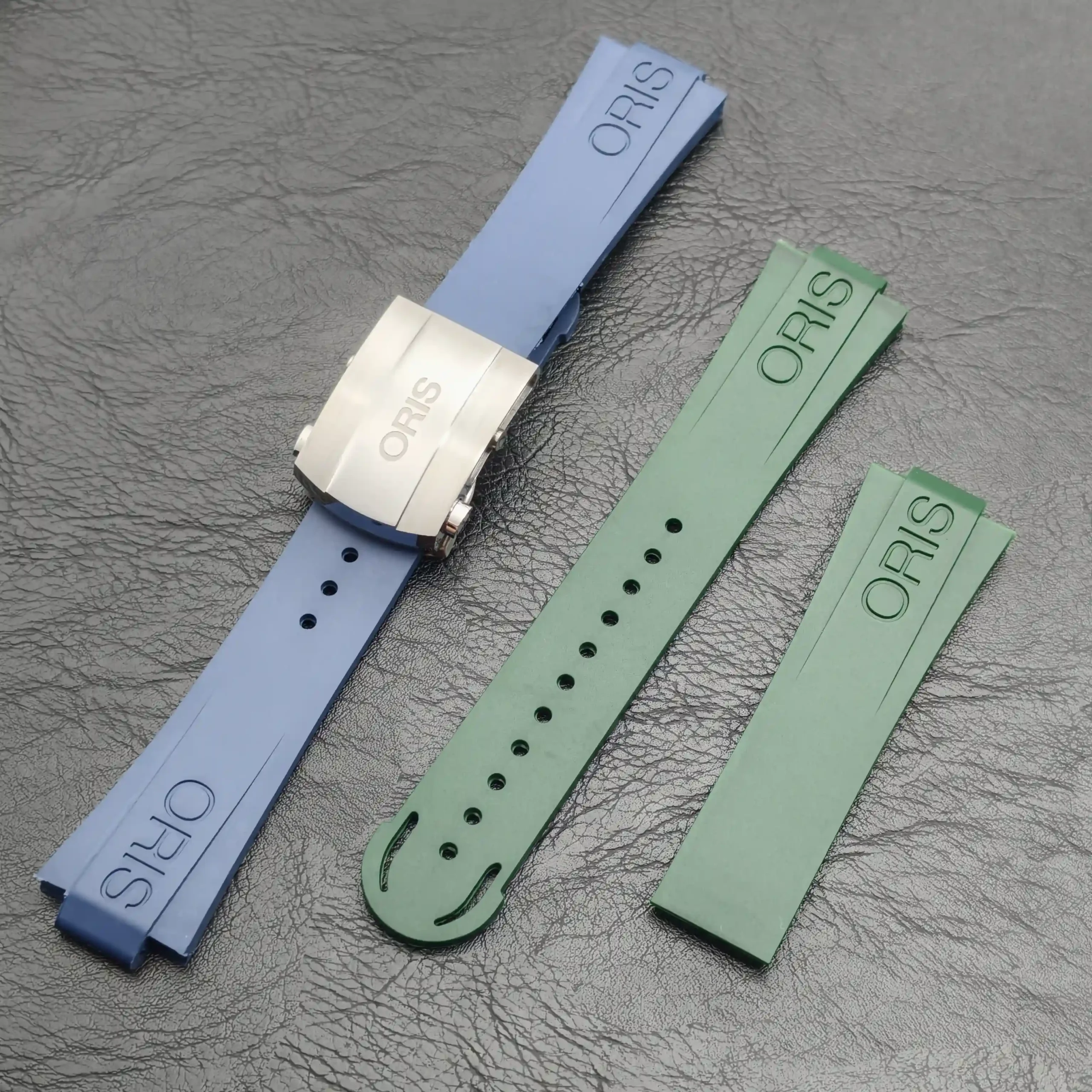 FKM rubber straps for Oris Aquis in blue, white and green, laid out diagonally.